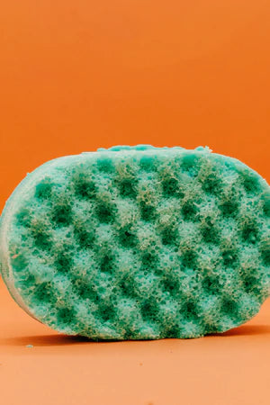 Front View Of A Green Soap Sponge On A Orange Background
