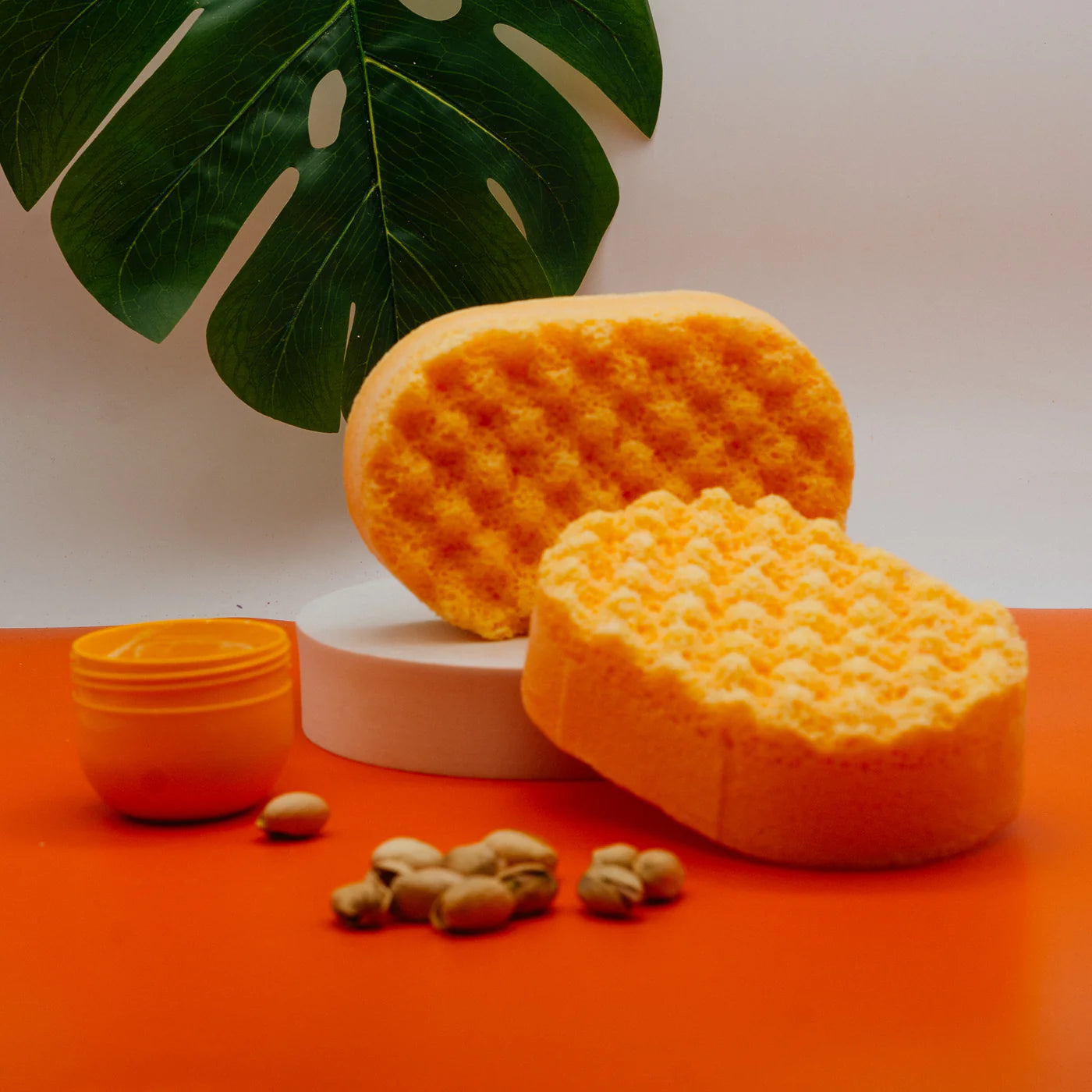 Orange Soap with peanuts a cream pot leaf in the back ground sitting on a orange background